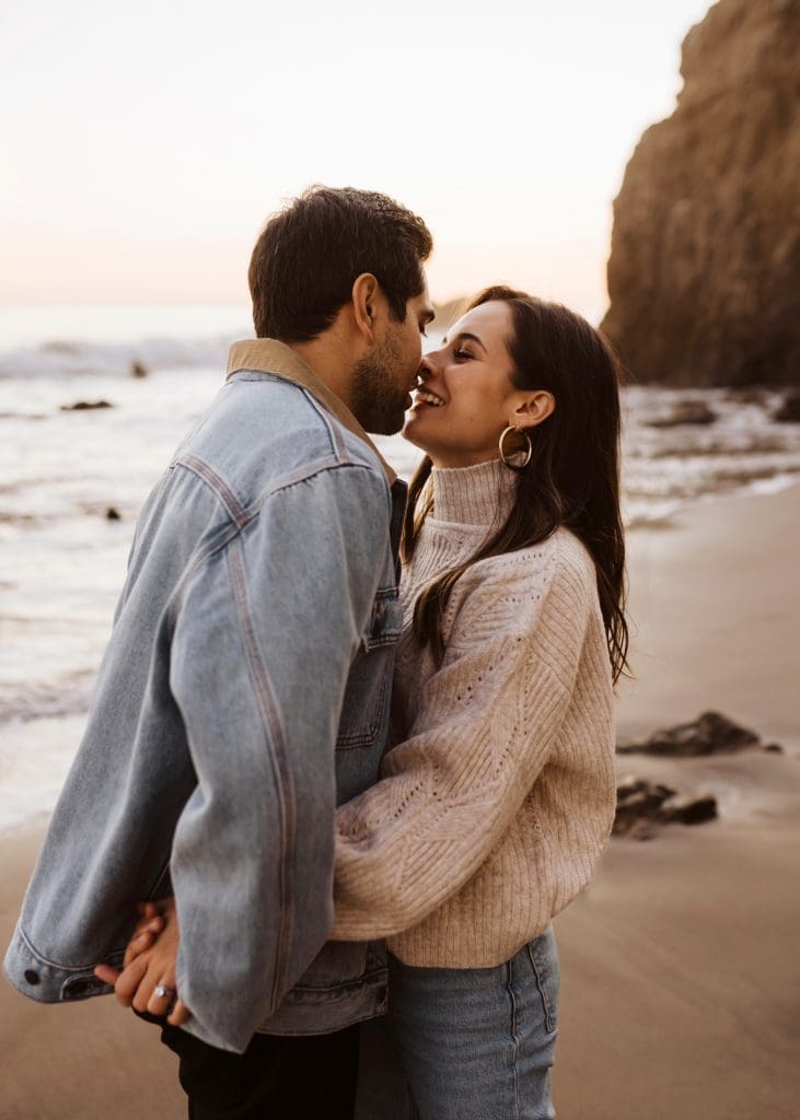 Happy Couple During Malibu Beach Engagement Session | Kelly O'Connor Photography | Austin Based Wedding Photographer | El Matador Beach | couples poses, couple smiling at each other, beach photos, casual beach photos, outfit ideas for engagement photos, outfit ideas for beach | via kellyoconnorphotography.com
