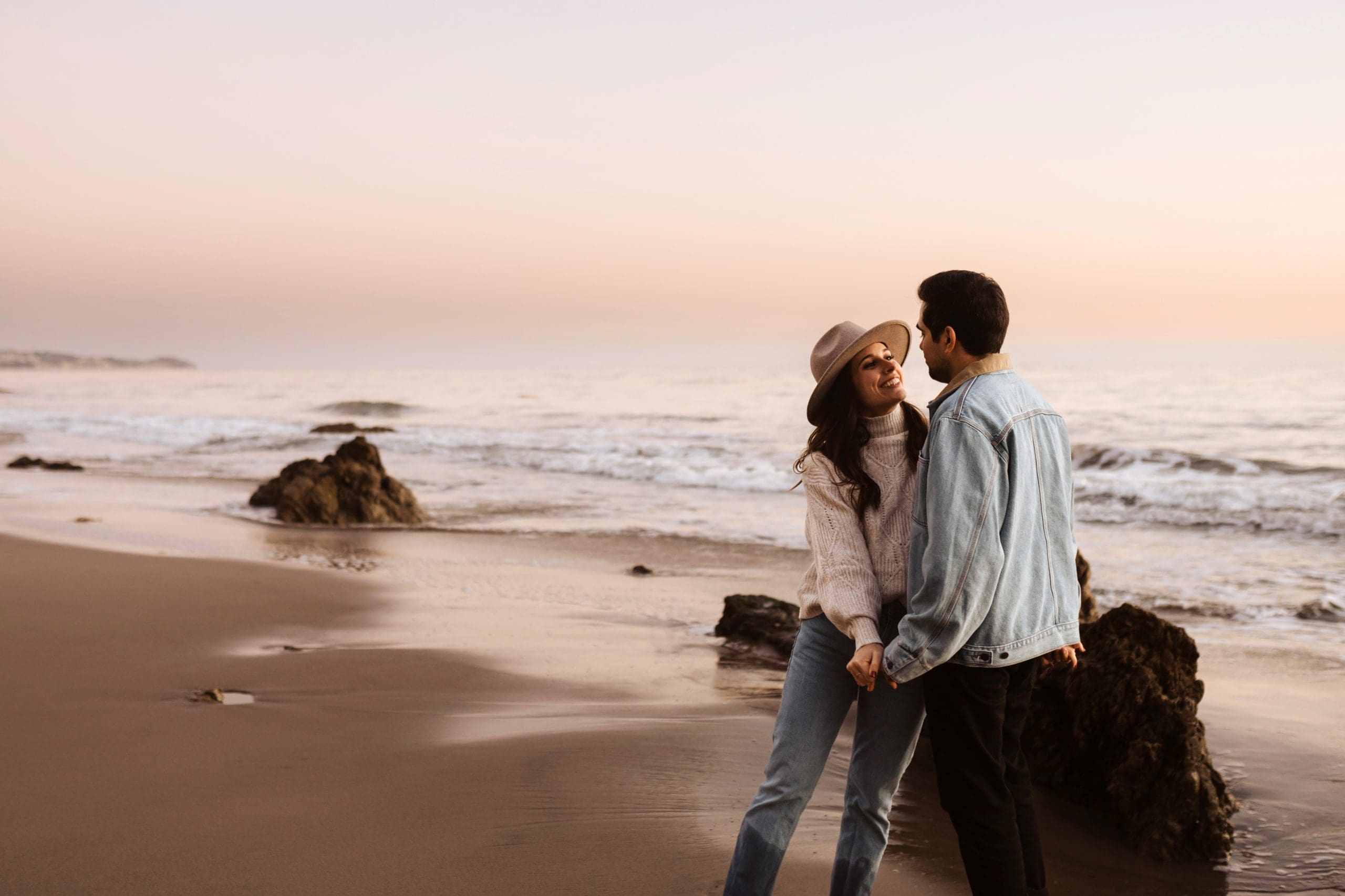 Happy Couple During Malibu Beach Engagement Session | Kelly O'Connor Photography | Austin Based Wedding Photographer | El Matador Beach | couples poses, couple smiling at each other, beach photos, casual beach photos, outfit ideas for engagement photos, outfit ideas for beach | via kellyoconnorphotography.com