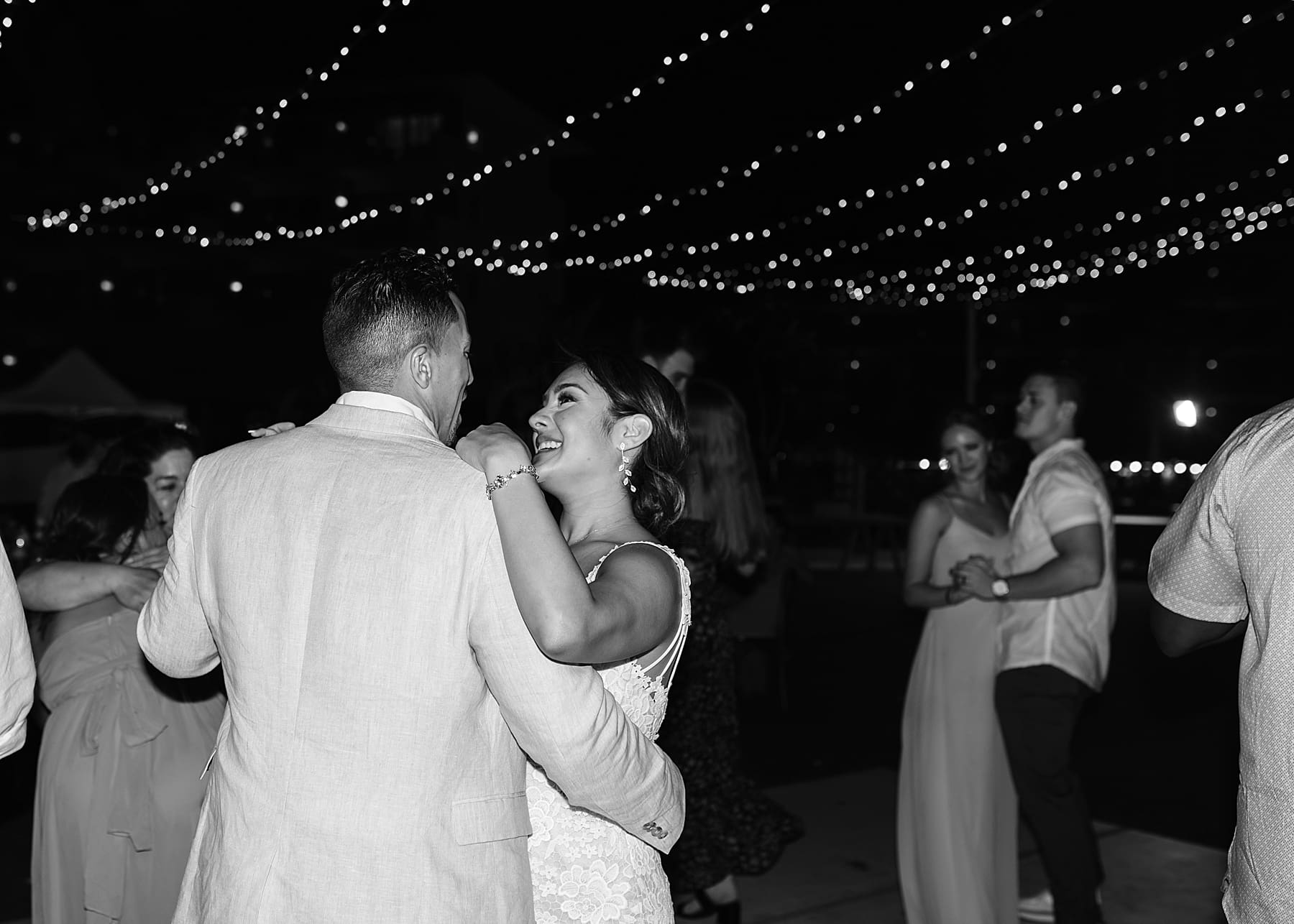 Outdoor wedding reception under draped lights in Mexico | Kelly O'Connor Photography | Destination Wedding Photographer | Dreams Playa Mujeres Wedding | first dance, reception photos, guests dancing | via kellyoconnorphotography.com