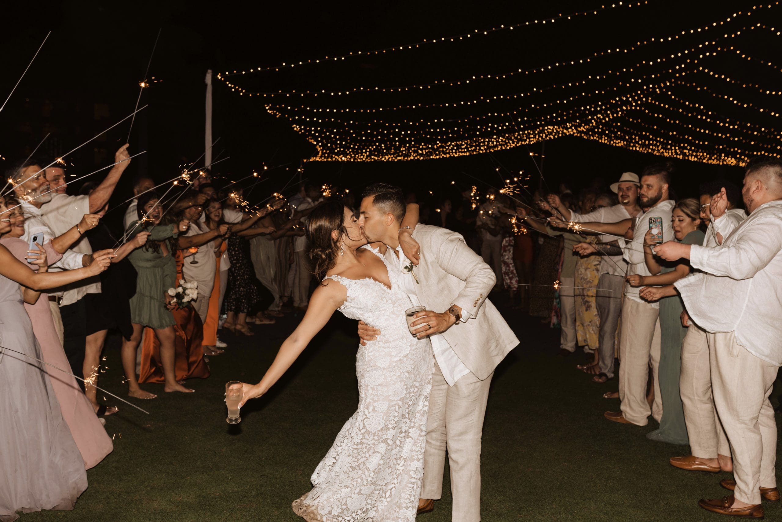 Outdoor wedding reception under draped lights in Mexico | Kelly O'Connor Photography | Destination Wedding Photographer | Dreams Playa Mujeres Wedding | first dance, reception photos, guests dancing | via kellyoconnorphotography.comk
