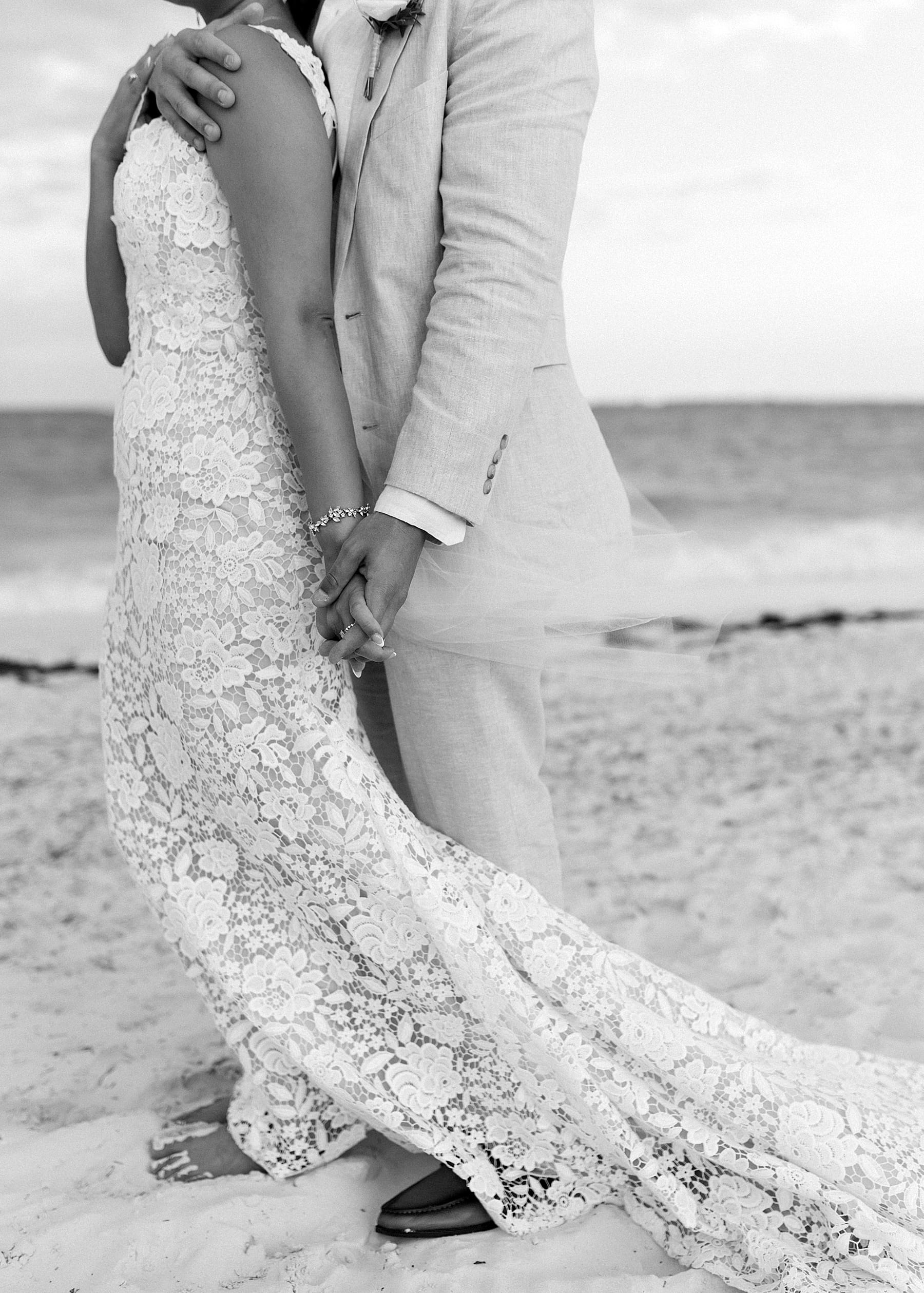 Black and white portrait of bride and groom details on wedding day at beach