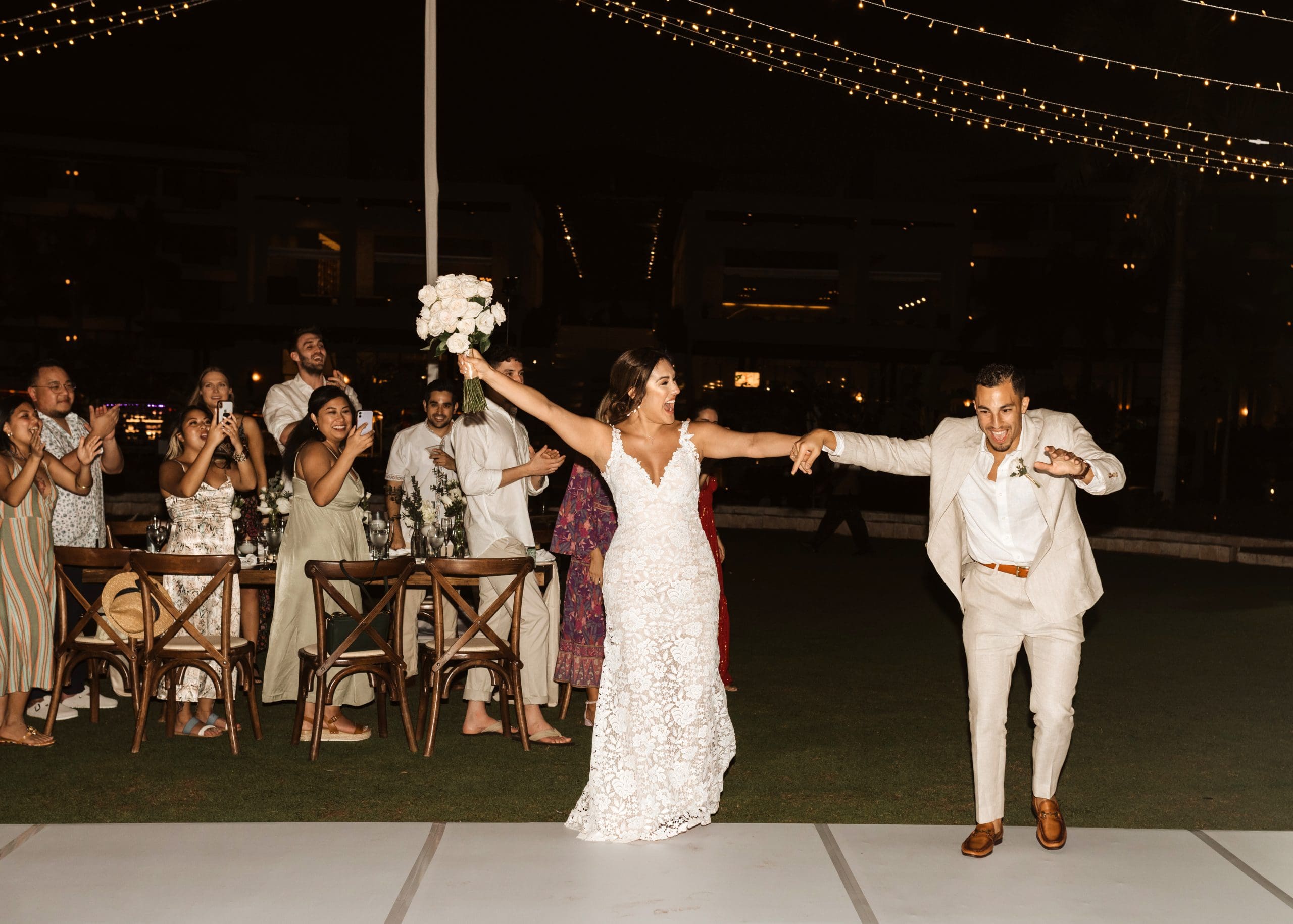 Outdoor wedding reception under draped lights in Mexico | Kelly O'Connor Photography | Destination Wedding Photographer | Dreams Playa Mujeres Wedding | first dance, reception photos, guests dancing | via kellyoconnorphotography.com