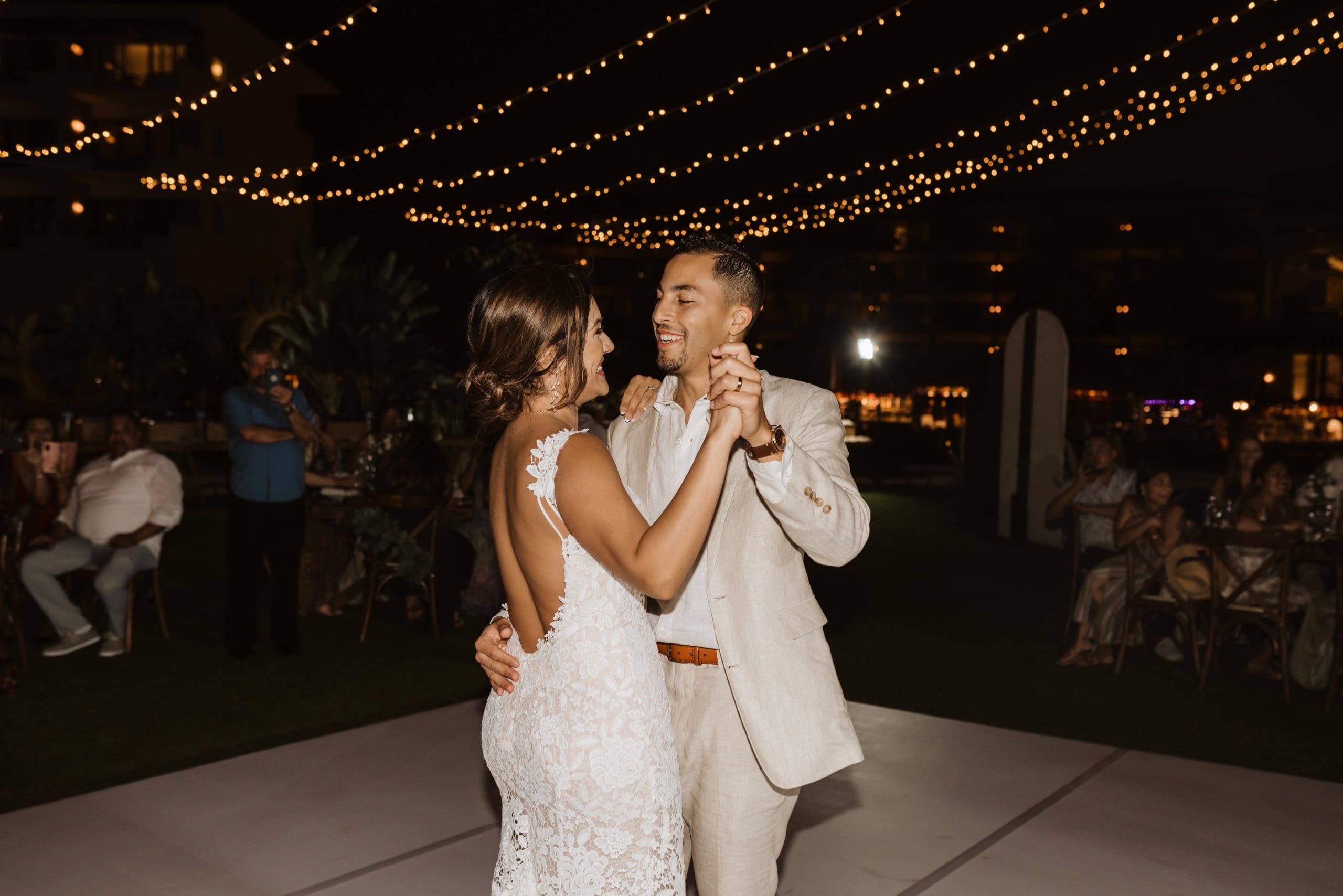 Outdoor wedding reception under draped lights in Mexico | Kelly O'Connor Photography | Destination Wedding Photographer | Dreams Playa Mujeres Wedding | first dance, reception photos, guests dancing | via kellyoconnorphotography.com