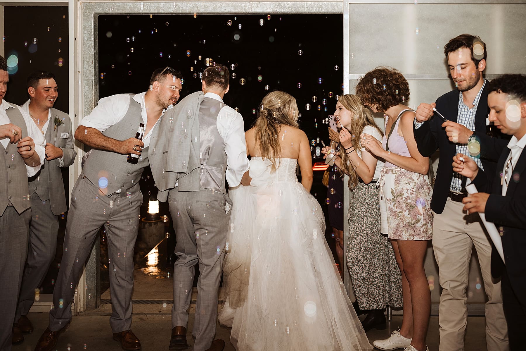 Bubble grand exit at rainy wedding day | Kelly O'Connor Photography | Austin Wedding Photographer | Prospect House Wedding Day | edgy wedding ideas, bride in converse | via kellyoconnorphotography.com