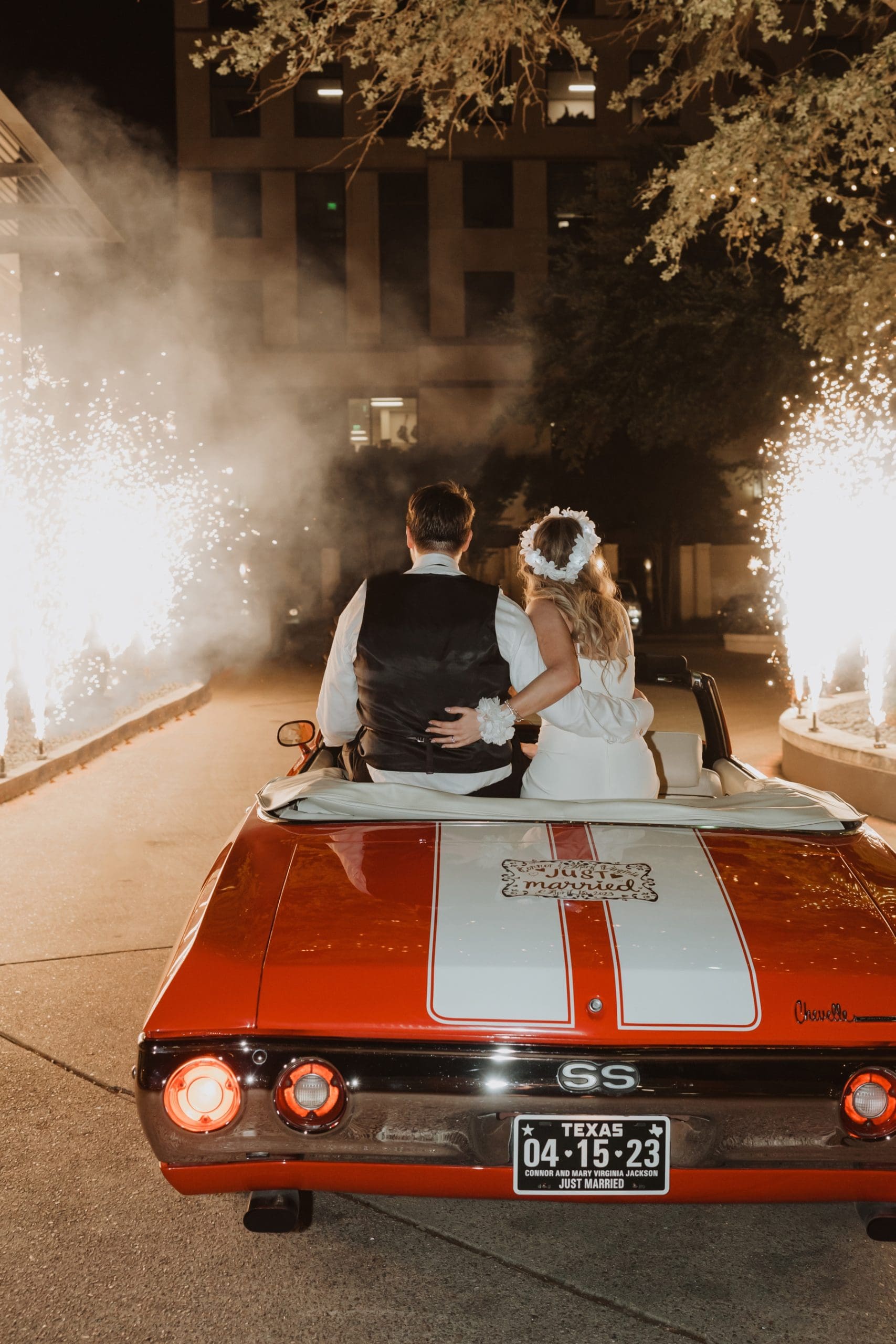 A vintage car wedding send off with a twist - cold sparklers! Loved the joy on their faces when they were surprised with this. | Spring Wedding in Texas | Kelly O'Connor Photography
