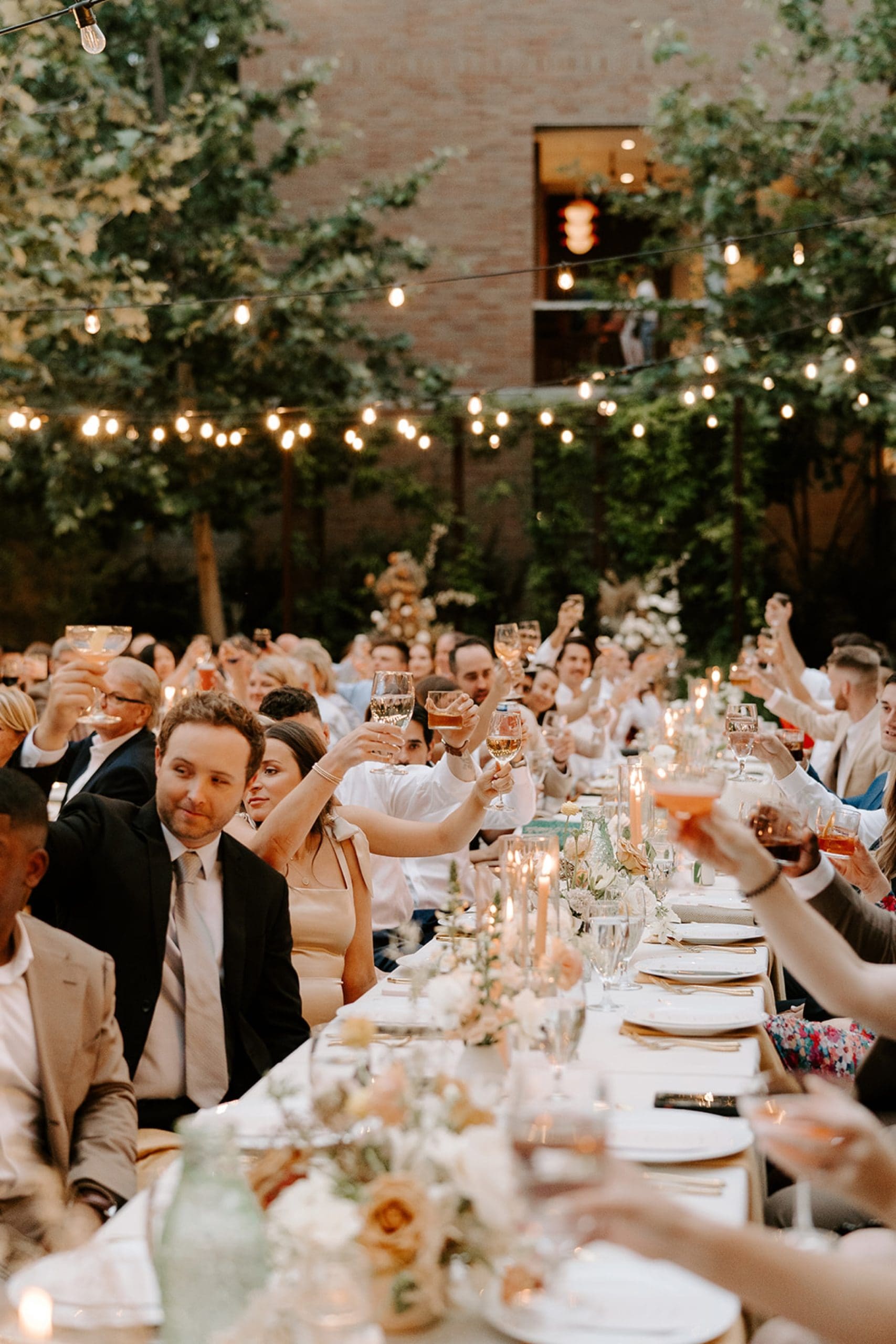 Outdoor wedding reception under twinkle lights in Hotel Magdelena courtyard in Austin, Texas. | Kelly O'Connor Photography