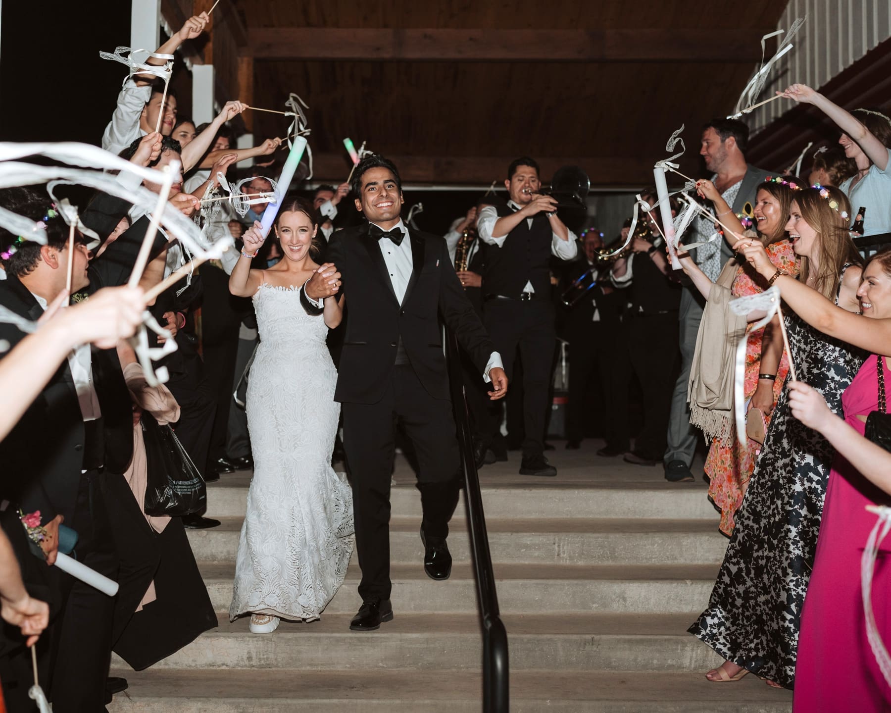 Bride and groom exiting with ribbon streamers after destination Colorado wedding 
