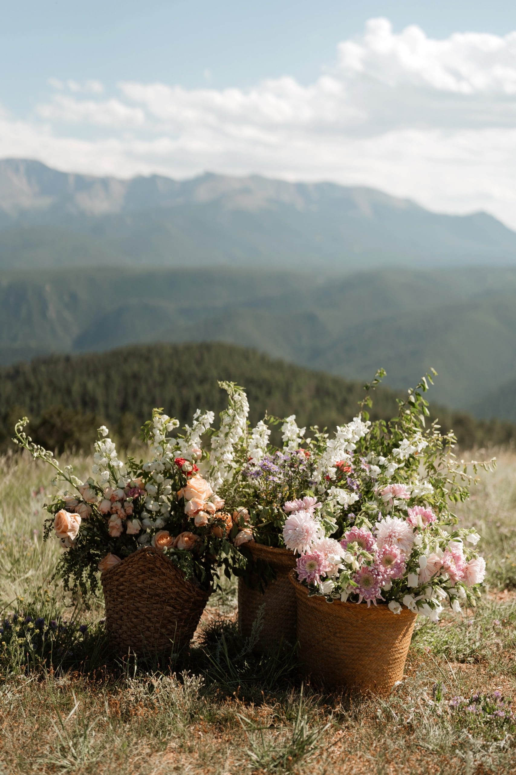 Baskets full of wildflower arrangements at destination Colorado wedding 
