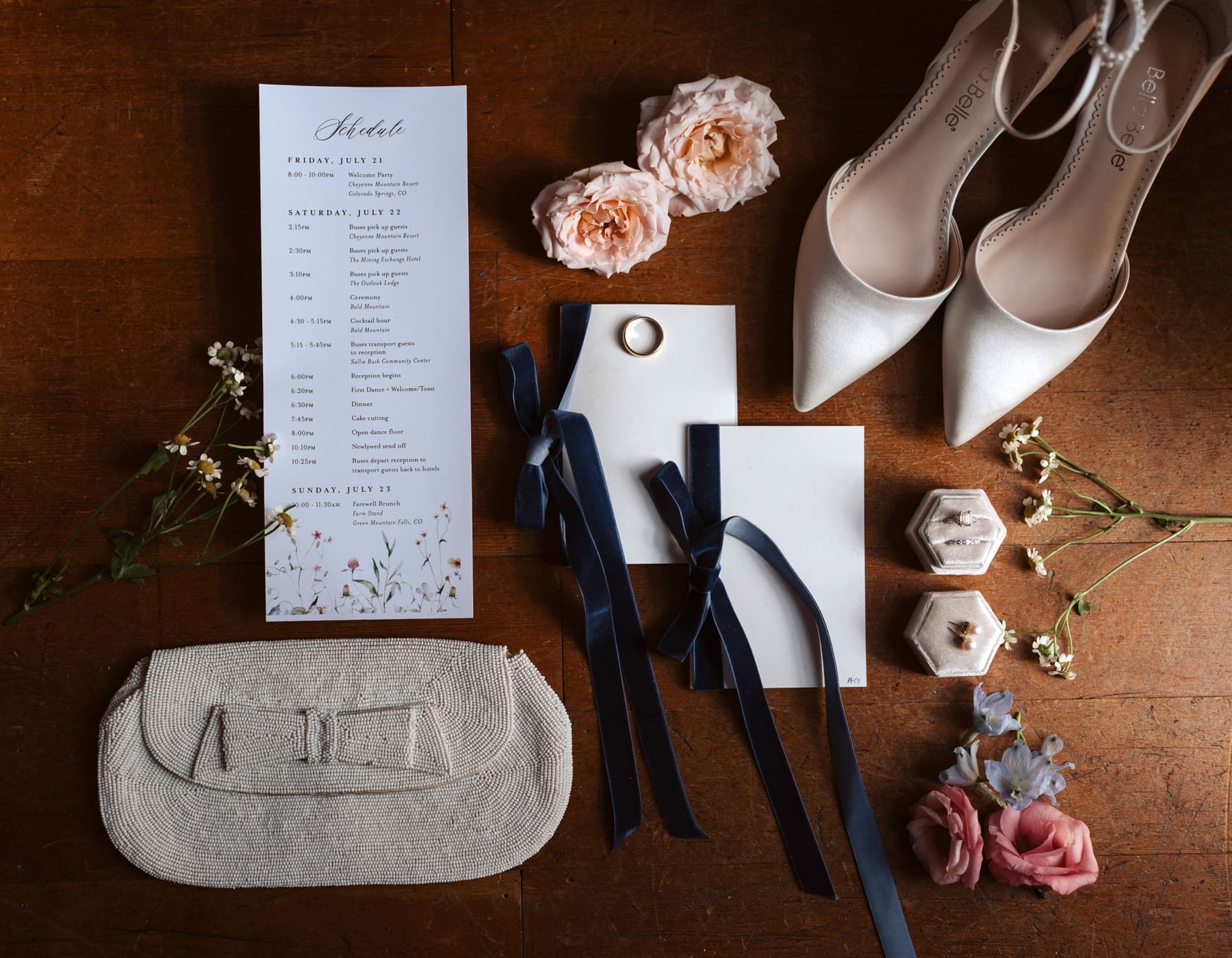 Classical bridal details featuring itinerary with floral details