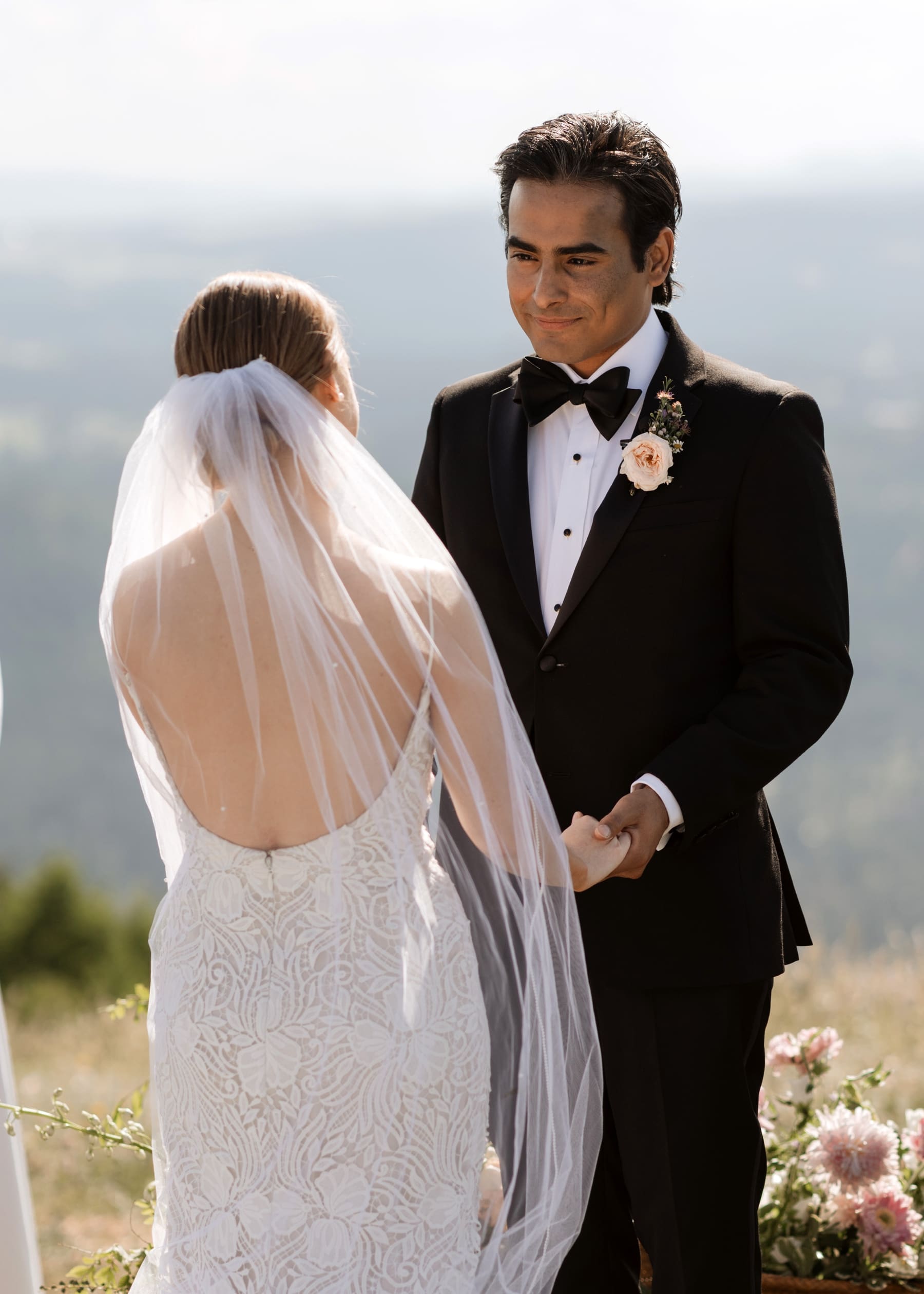 Groom looking at bride during destination Colorado wedding ceremony 