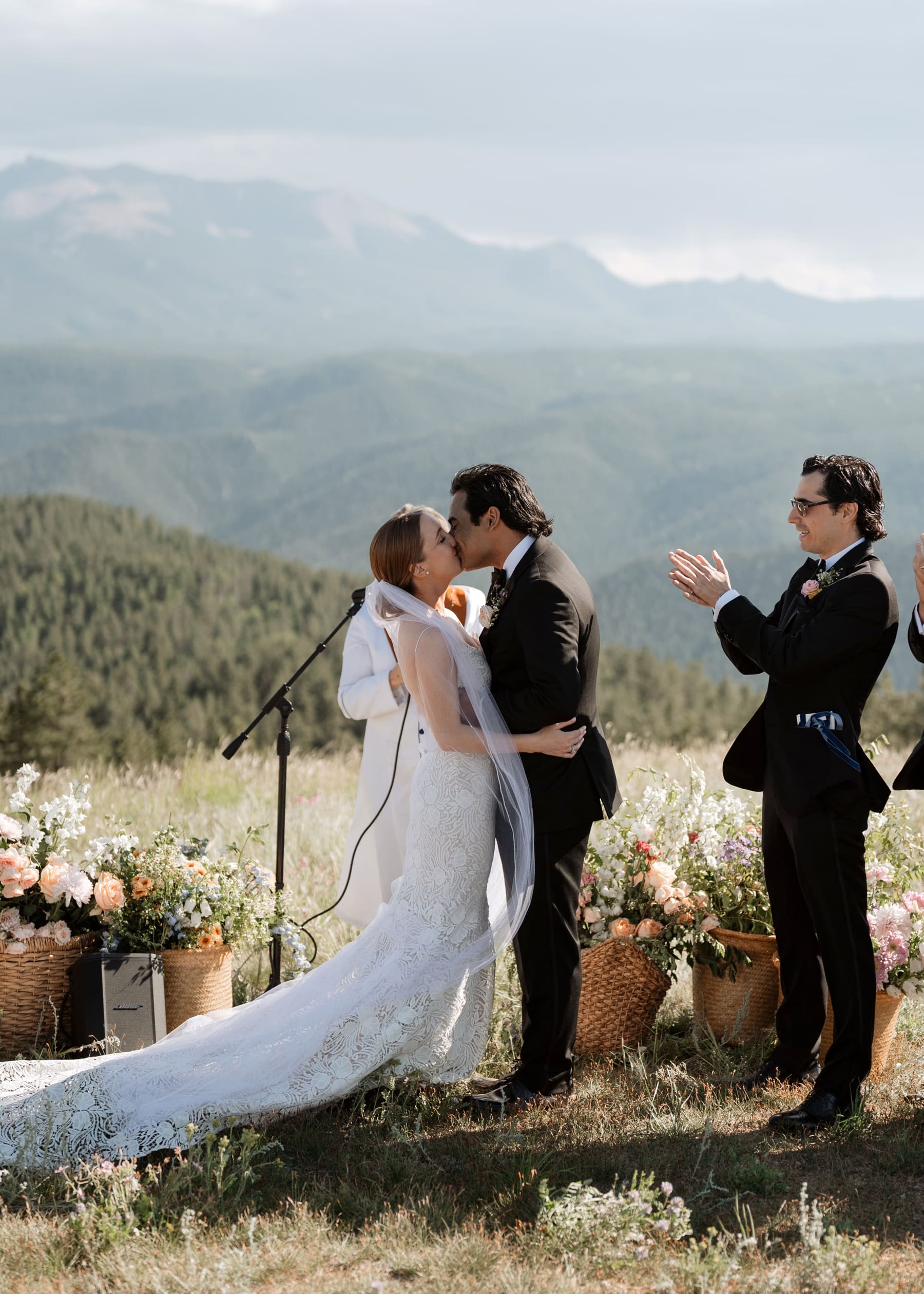 Bride and groom kissing at end of Colorado wedding ceremony 