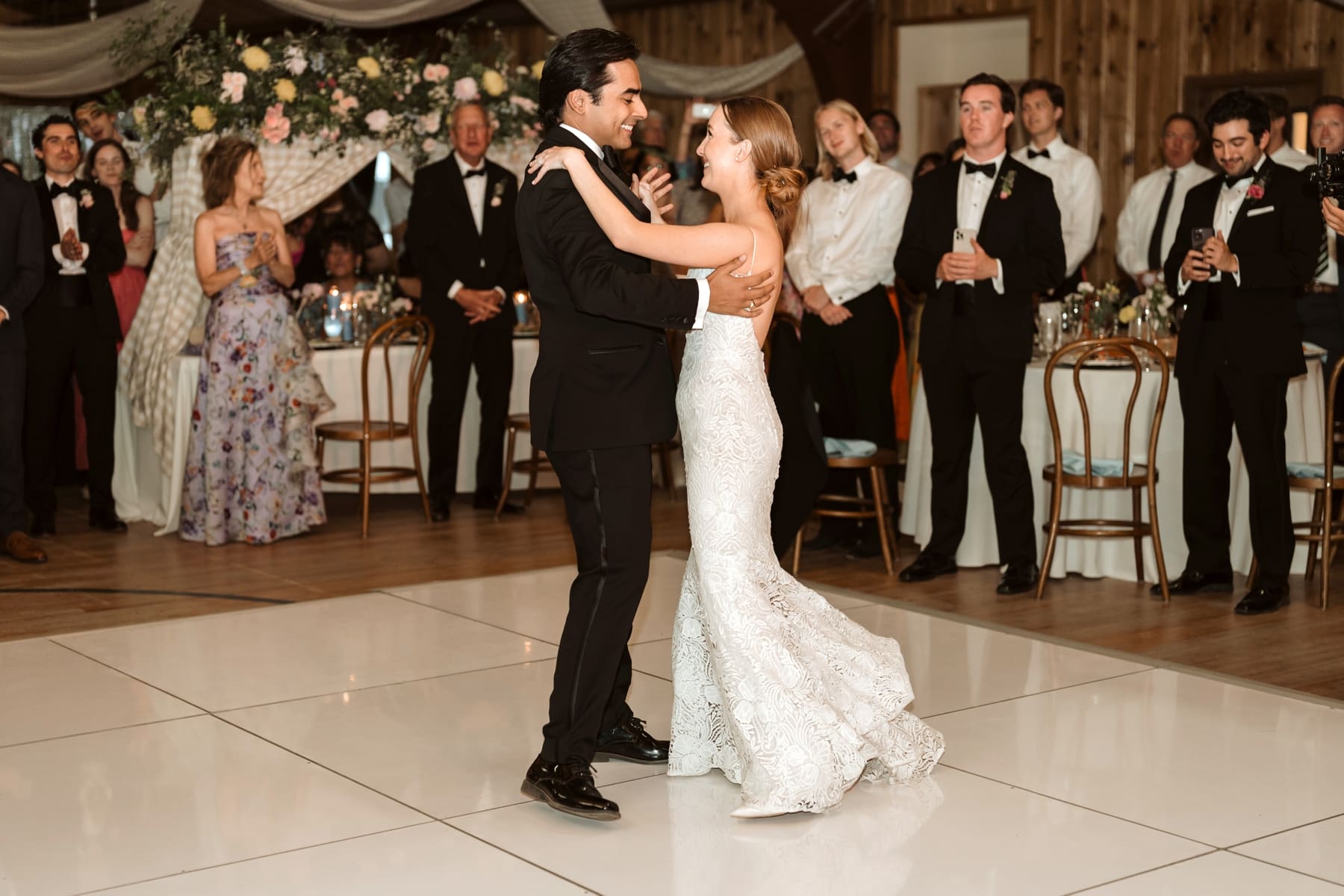 Bride and groom dancing during first dance at wedding at Sallie Bush Community Building