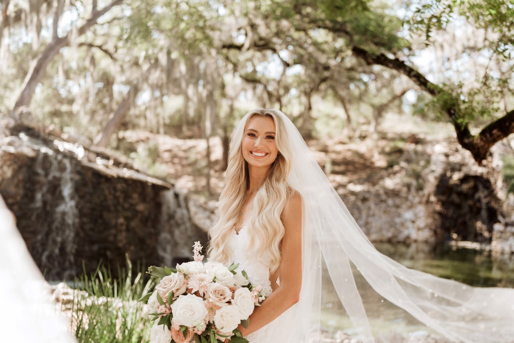 Bride with veil flowing in the wind during bridal portraits