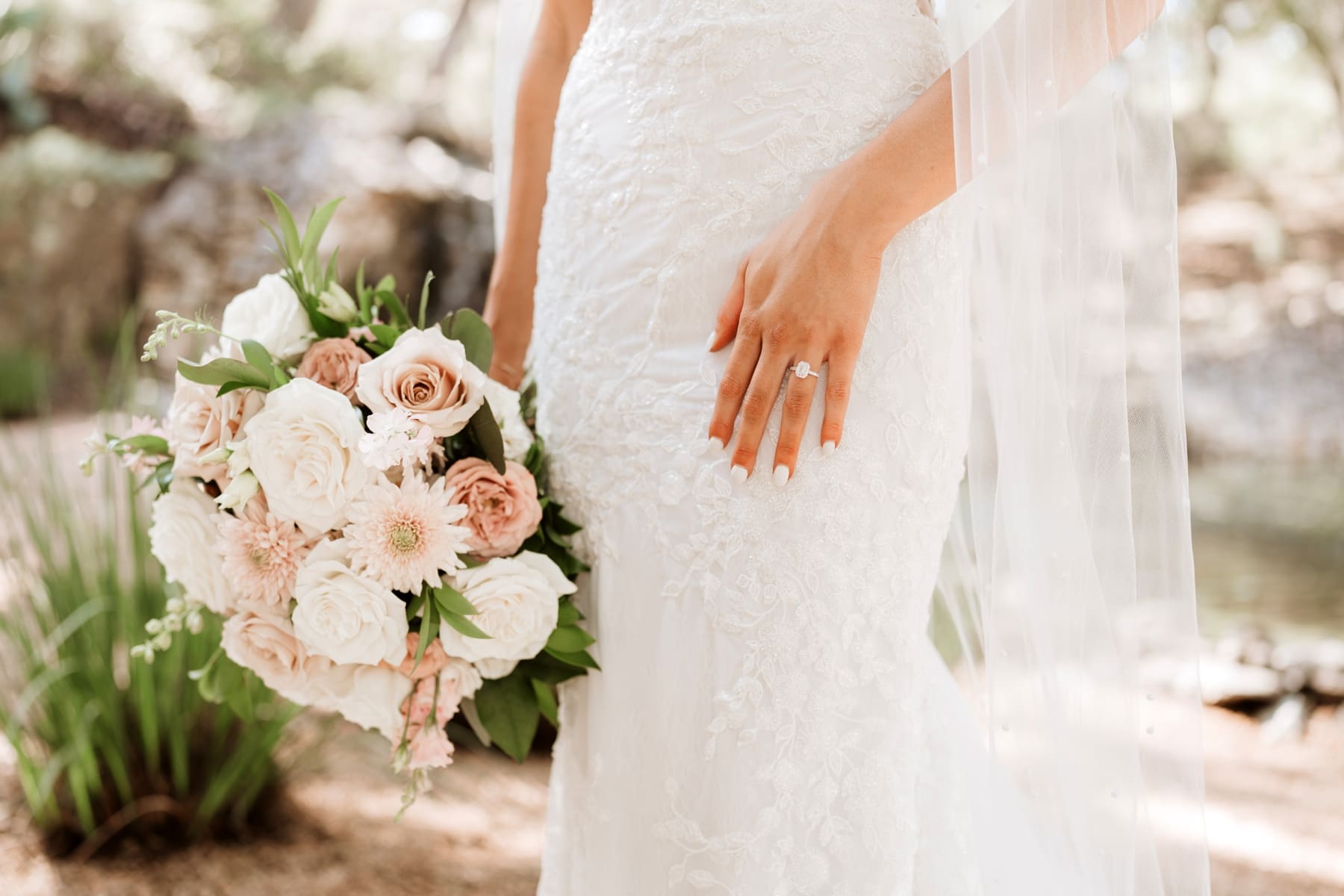 Detailed view of bride's ring and pink and white bouquet