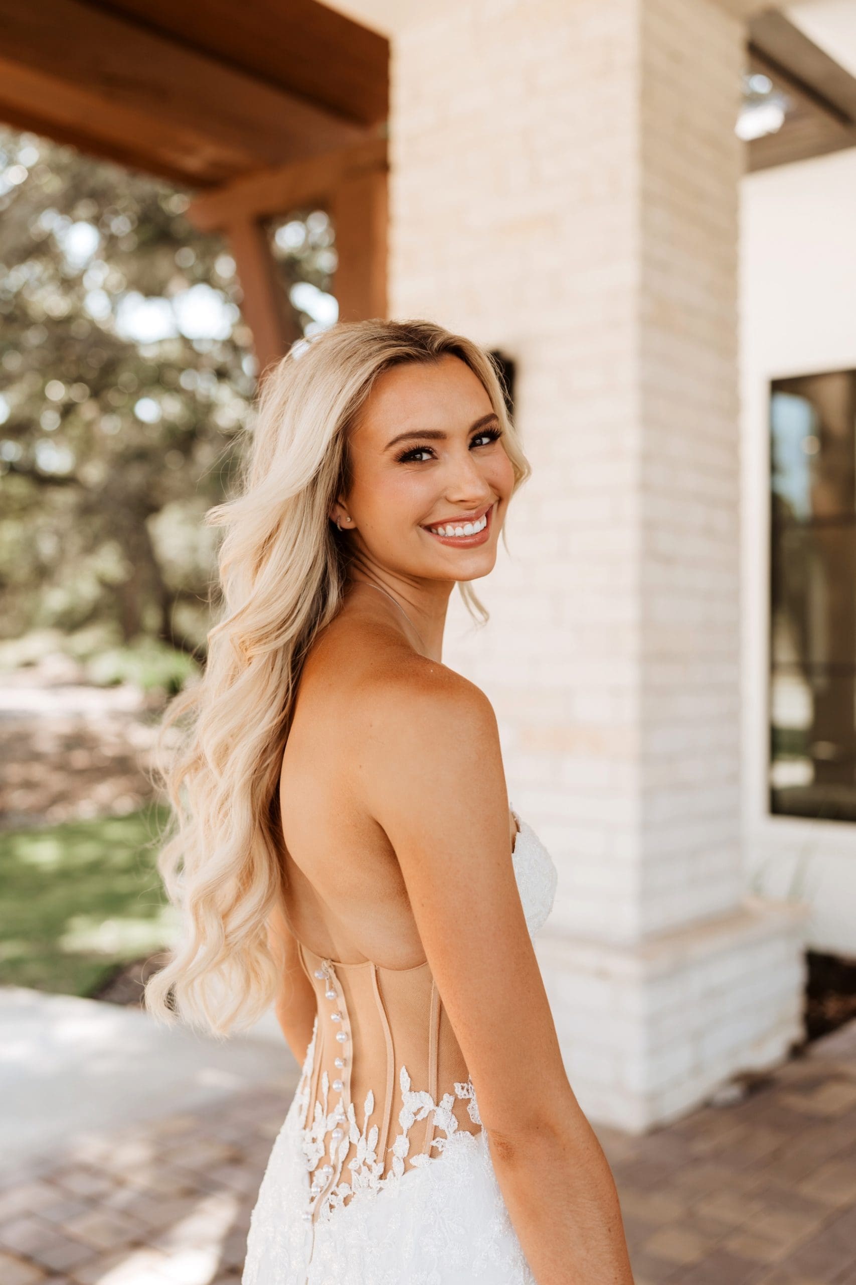 Bride looking over shoulder wearing see through corset dress