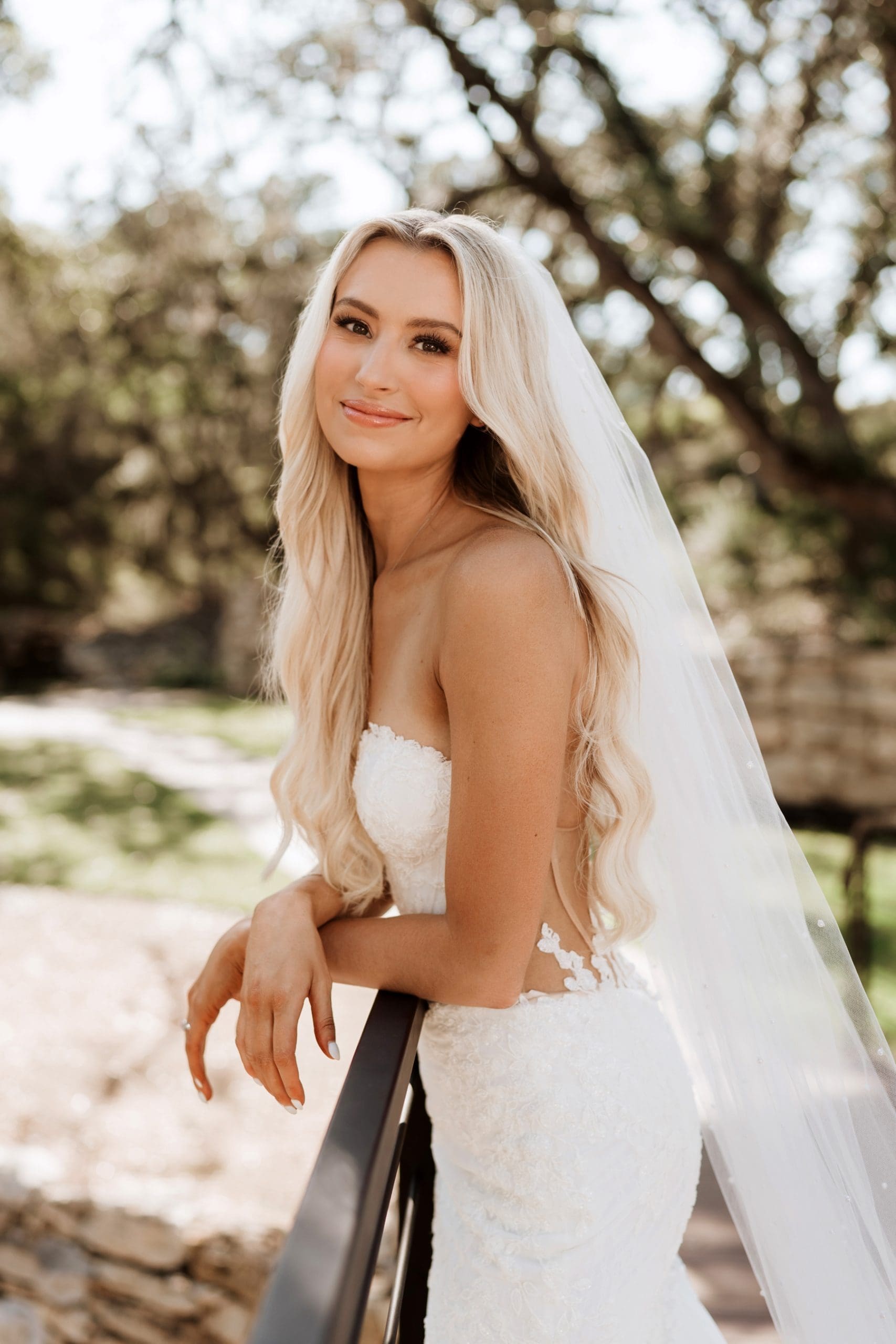 Bride leaning against bridge during bridal portraits at Hayes Hollow at Hidden Falls