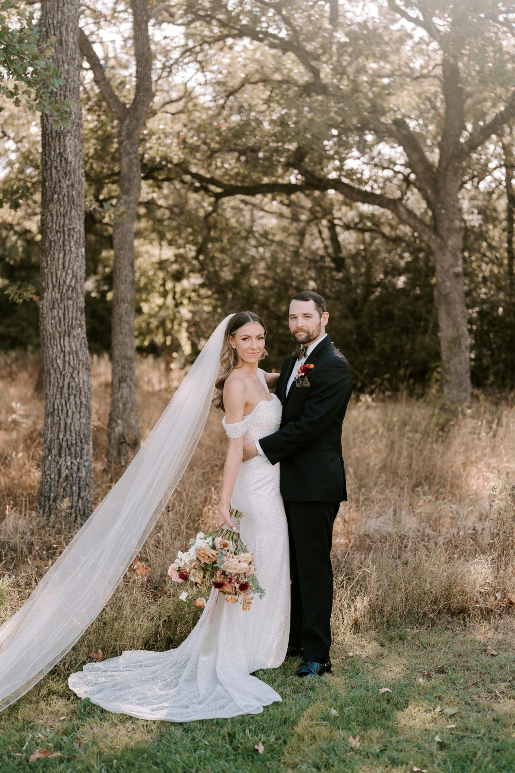 Bride and groom taking photos in wooded area at The Grand Lady Austin